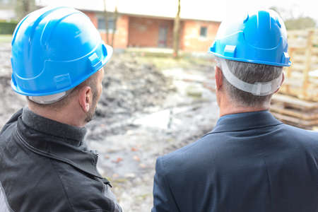 Owner and contractor outsides the construction siteの写真素材