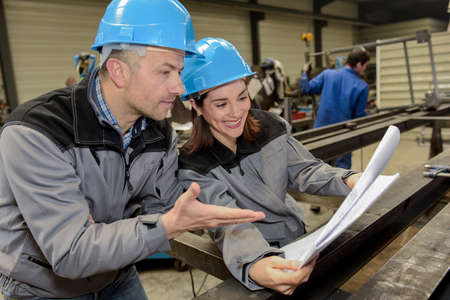 Female worker finds funny his colleague's ideaの写真素材
