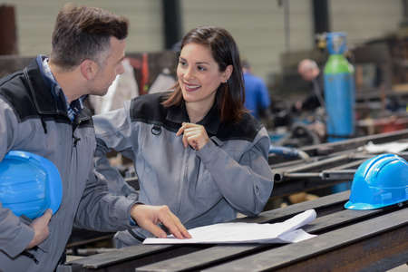 Happy female worker agrees with male colleagueの写真素材