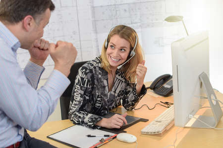 The team shares a new commercial success in their jobの写真素材