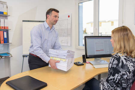 transmissiopn of a big work file between the boss and his secretary.の写真素材