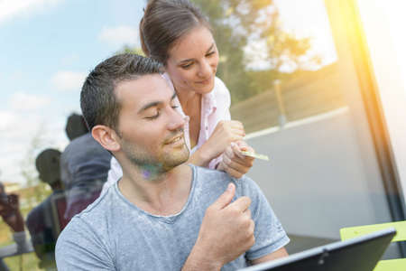 Couple on video call with a tablet outdoorsの写真素材