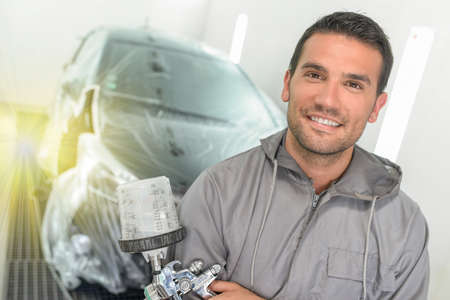 Portrait of a car body painter in his paint boothの写真素材
