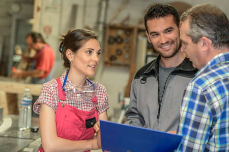 The boss gives instruction to his employeesの写真素材