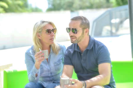 coffee break for an accomplice couple outside in their gardenの写真素材