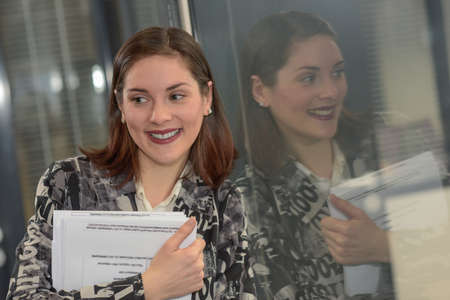 Happy business woman is smiling at the cameraの写真素材