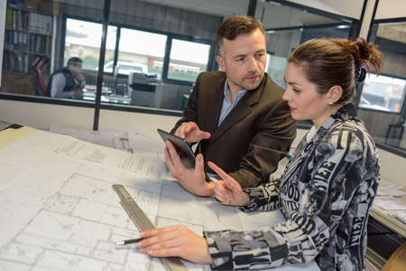 Architects discuss a new project over a tabletの写真素材