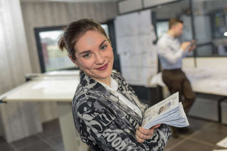 Serious working woman in a architect's officeの写真素材
