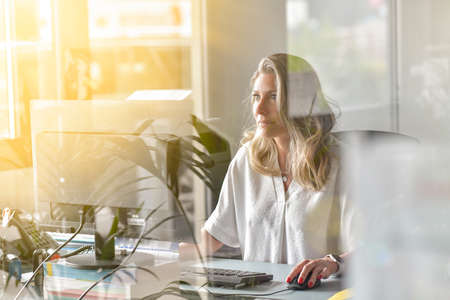 Business woman working at her deskの写真素材