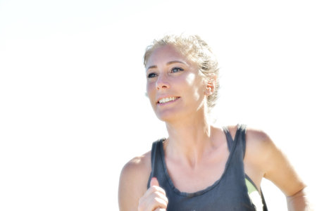 Female jogger during her running session along a river in the cityの写真素材