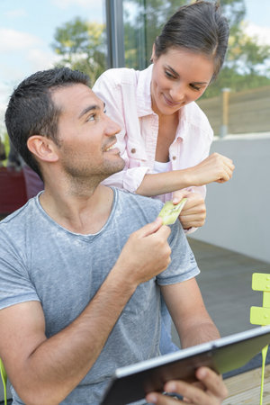 Couple on video call with a tablet outdoorsの写真素材