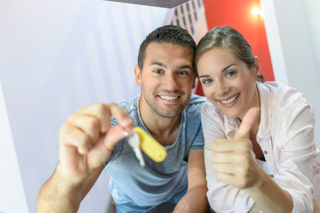 Portrait of a cute young couple in their new flatの写真素材