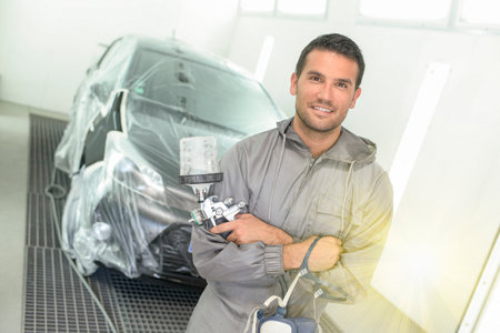 Portrait of a car body painter in his paint boothの写真素材