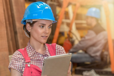 Workers check the stock in a carpentryの写真素材