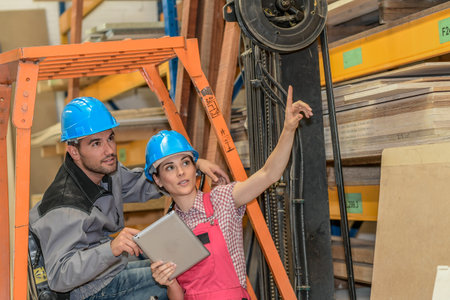 Workers check the stock in a carpentryの写真素材