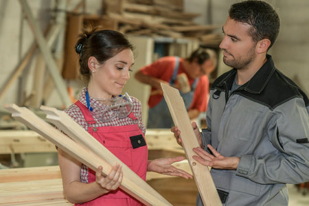 Carpenters checking their production in the workshopの写真素材