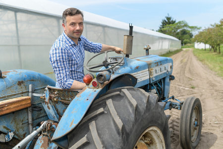 Male farmer drives his tractorの写真素材