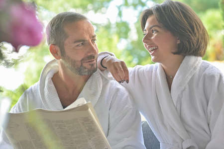 Father daughter complicity and relationship, manipulation in the garden during breakfastの写真素材