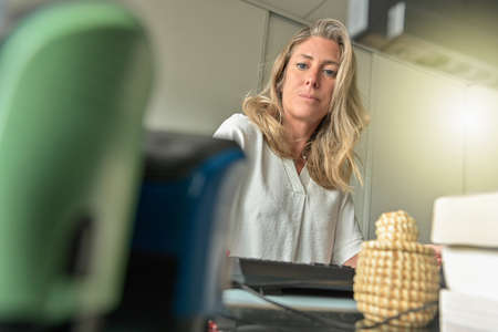 Business woman working at her deskの写真素材