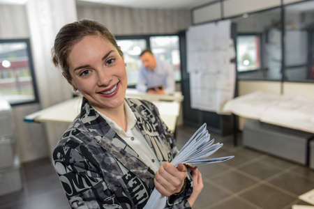 Smiling working girl in a officeの写真素材