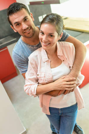Portrait of a happy young couple in their kitchenの写真素材