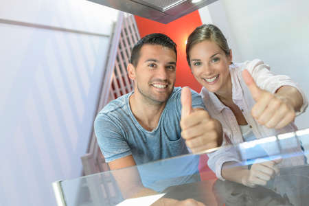 Portrait of a cute young couple in their new flatの写真素材