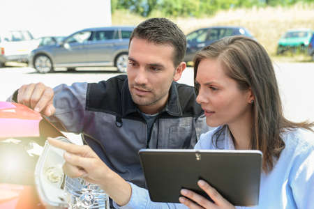 Expert checks the cost of a car reparation