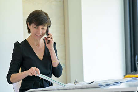 Portrait of a female architect sitting at her desk working on a new construction project