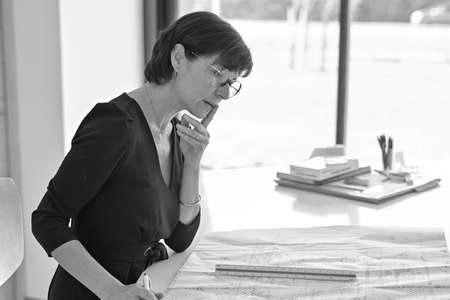 Portrait of a female architect sitting at her desk working on a new construction projectの写真素材