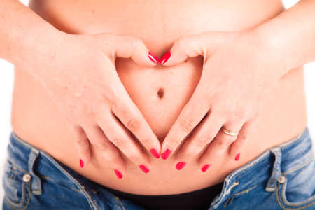 A maternity portrait of a woman at eight months along in her pregnancy の写真素材