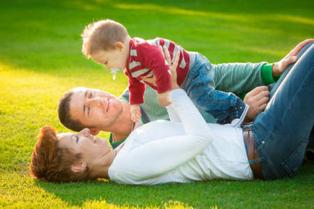 Family playing on grass in the parkの写真素材