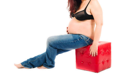 A maternity portrait of a woman at eight months along in her pregnancy の写真素材