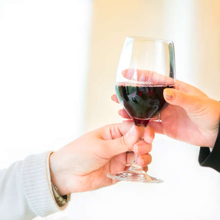 Waiter pouring  red wine on a party