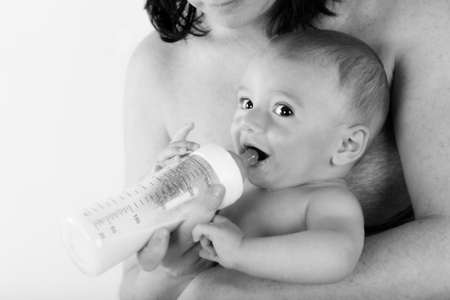 baby drinks milk from the baby bottleの写真素材