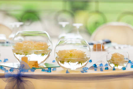 vase of pink roses and candlesの写真素材