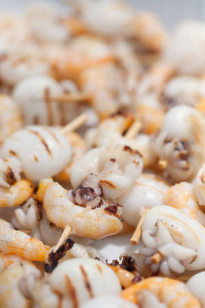 spiedini of cuttlefishes and shrimps on the grill