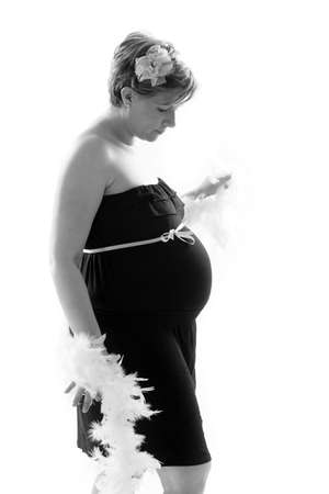 A maternity portrait of a woman at eight months along in her pregnancy の写真素材
