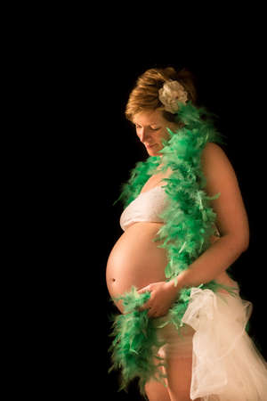 A maternity portrait of a woman at eight months along in her pregnancy の写真素材