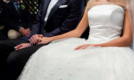 bride and groom hands with wedding ringsの写真素材