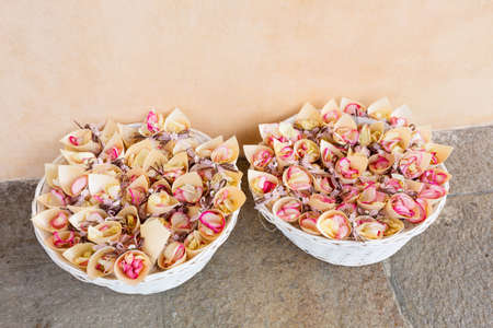 white baskets with roses petals for weddingの写真素材