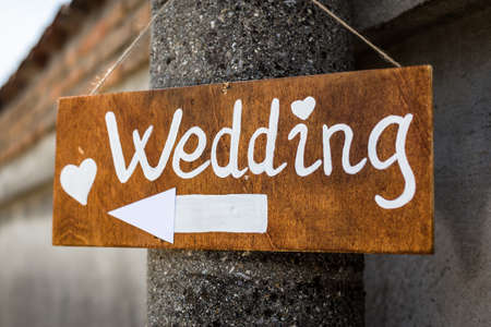 wooden sign indicates wedding reception