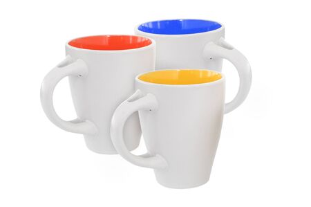 Three multicolored mugs, isolated on whiteの写真素材
