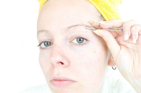 young woman cleaning her eyebrowsの写真素材