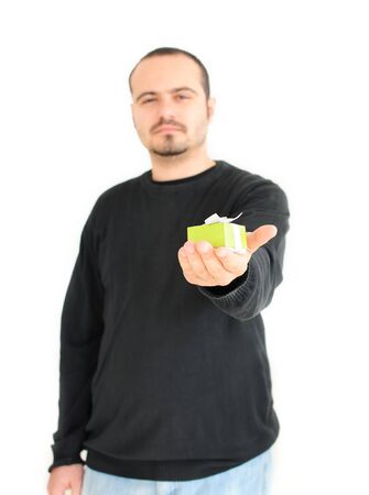 Young man gifting small presentの写真素材