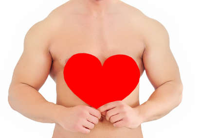 Young topless man holding red heartの写真素材