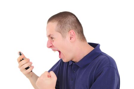 Angry young man shouting on the phoneの写真素材