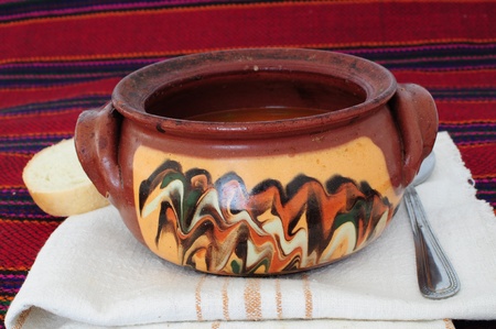 Traditional dish served in decorated clay pot for cookingの写真素材