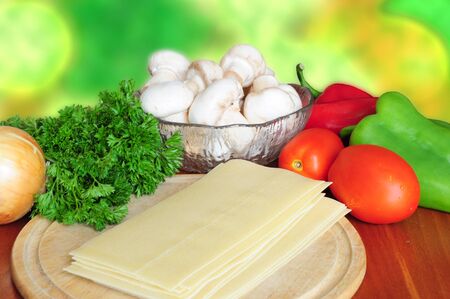 Ingredients for lasagna - tomatoes, pepper, parsley, mushrooms, onion, pastaの写真素材