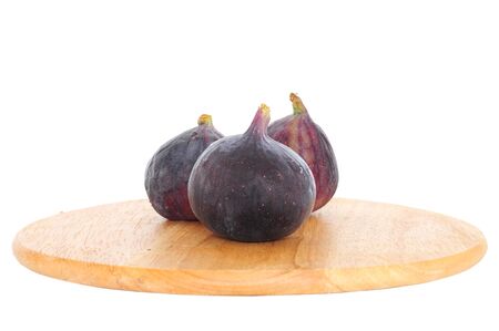 Fresh whole figs on wooden board isolated onwhite backgroundの写真素材