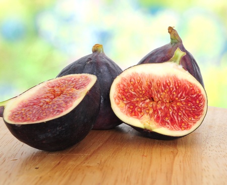 Fresh cut fig halves on wooden boardの写真素材
